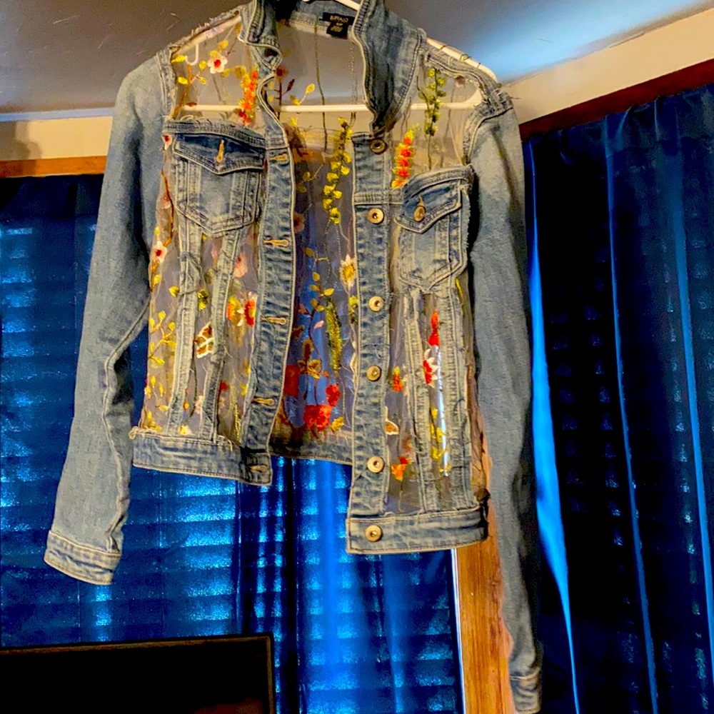 A Jean jacket with see through embroidery.